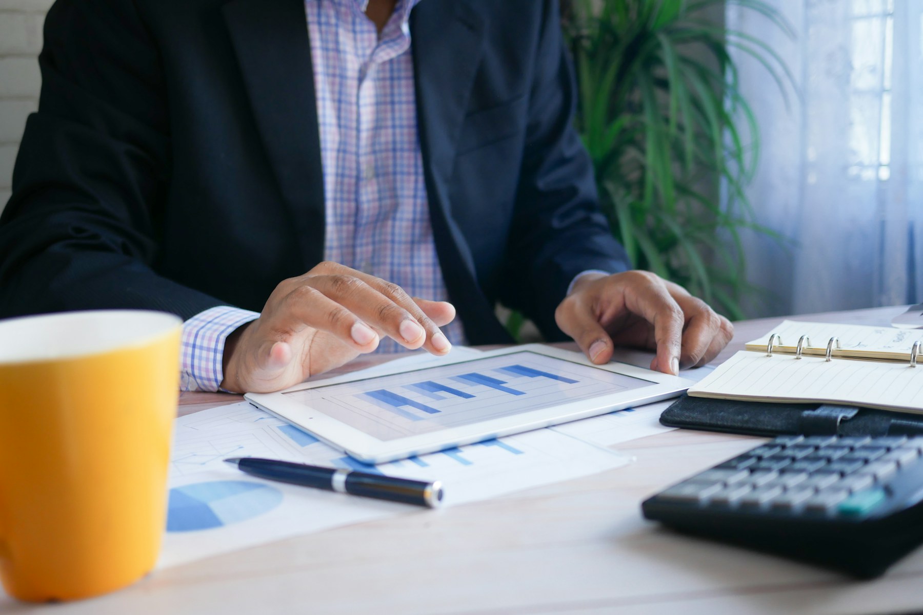 Finance operator reviewing business reports on a tablet